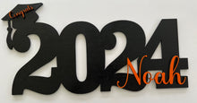 Load image into Gallery viewer, Celebrate your graduate with this personalized wooden graduation sign. An ideal alternative to a traditional guestbook, it features their graduation year, making it a great photo prop for the special day. Show your support in style with this meaningful keepsake.
