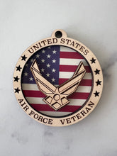 Load image into Gallery viewer, Celebrate the heros that fought for our freedom with these Military Medallions.  These 4” round ornaments display a flag background and your choice of military insignias on the front.  The perfect way to thank the veterans or active duty hero’s in your life.