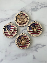 Load image into Gallery viewer, Celebrate the heros that fought for our freedom with these Military Medallions.  These 4” round ornaments display a flag background and your choice of military insignias on the front.  The perfect way to thank the veterans or active duty hero’s in your life.
