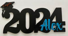 Load image into Gallery viewer, Celebrate your graduate with this personalized wooden graduation sign. An ideal alternative to a traditional guestbook, it features their graduation year, making it a great photo prop for the special day. Show your support in style with this meaningful keepsake.