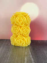 Load image into Gallery viewer, Bring timeless elegance and the warm glow of natural beeswax into your home with this handcrafted Rose Beeswax Pillar Candle. Beautifully sculpted with delicate rose petals, this stunning floral candle creates a cozy ambiance while showcasing the natural beauty of pure American beeswax.