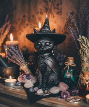 Load image into Gallery viewer, Celebrate the magic of Halloween with this enchanting Black Cat Beeswax Candle, handcrafted from 100% pure American beeswax. Featuring a charming black cat wearing a classic witch's hat adorned with a mystical triple moon symbol and skull centerpiece, this candle is the perfect accent for Halloween displays, gothic home décor, altars, and witchy spaces.