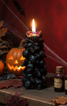 Load image into Gallery viewer, Unleash the spooky vibe with our one-of-a-kind bleeding skull beeswax candle. As it burns, watch in awe as the 'blood' oozes and the skulls roll off onto the plate, adding an eerie touch to your Halloween decorations. The glowing eyes and piles of skulls and bones make this pillar candle a must-have for gothic and fall decor. Perfect for gifting to skull-loving friends or for adding a touch of horror to any room. Get yours now and bring the creepy factor to your home!