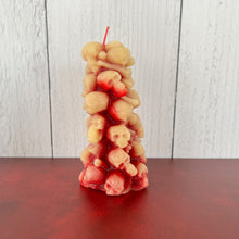 Load image into Gallery viewer, Unleash the spooky vibe with our one-of-a-kind bleeding skull beeswax candle. As it burns, watch in awe as the 'blood' oozes and the skulls roll off onto the plate, adding an eerie touch to your Halloween decorations. The glowing eyes and piles of skulls and bones make this pillar candle a must-have for gothic and fall decor. Perfect for gifting to skull-loving friends or for adding a touch of horror to any room. Get yours now and bring the creepy factor to your home!
