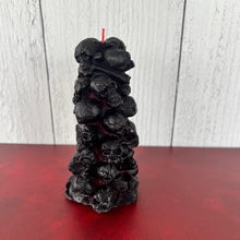 Load image into Gallery viewer, Unleash the spooky vibe with our one-of-a-kind bleeding skull beeswax candle. As it burns, watch in awe as the 'blood' oozes and the skulls roll off onto the plate, adding an eerie touch to your Halloween decorations. The glowing eyes and piles of skulls and bones make this pillar candle a must-have for gothic and fall decor. Perfect for gifting to skull-loving friends or for adding a touch of horror to any room. Get yours now and bring the creepy factor to your home!