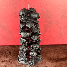 Load image into Gallery viewer, Unleash the spooky vibe with our one-of-a-kind bleeding skull beeswax candle. As it burns, watch in awe as the 'blood' oozes and the skulls roll off onto the plate, adding an eerie touch to your Halloween decorations. The glowing eyes and piles of skulls and bones make this pillar candle a must-have for gothic and fall decor. Perfect for gifting to skull-loving friends or for adding a touch of horror to any room. Get yours now and bring the creepy factor to your home!