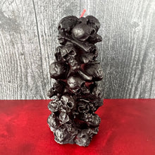 Load image into Gallery viewer, Unleash the spooky vibe with our one-of-a-kind bleeding skull beeswax candle. As it burns, watch in awe as the 'blood' oozes and the skulls roll off onto the plate, adding an eerie touch to your Halloween decorations. The glowing eyes and piles of skulls and bones make this pillar candle a must-have for gothic and fall decor. Perfect for gifting to skull-loving friends or for adding a touch of horror to any room. Get yours now and bring the creepy factor to your home!
