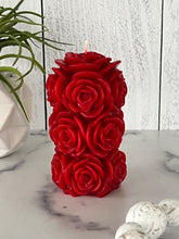 Load image into Gallery viewer, Bring timeless elegance and the warm glow of natural beeswax into your home with this handcrafted Rose Beeswax Pillar Candle. Beautifully sculpted with delicate rose petals, this stunning floral candle creates a cozy ambiance while showcasing the natural beauty of pure American beeswax.