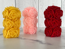 Load image into Gallery viewer, Bring timeless elegance and the warm glow of natural beeswax into your home with this handcrafted Rose Beeswax Pillar Candle. Beautifully sculpted with delicate rose petals, this stunning floral candle creates a cozy ambiance while showcasing the natural beauty of pure American beeswax.