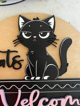 Load image into Gallery viewer, Let guests know exactly where they stand with this hilarious “Cats Welcome, People Tolerated” door hanger sign! Featuring an adorable black cat giving the ultimate snide side-eye look, this fun and sassy sign is the perfect addition to any cat lover’s home décor.