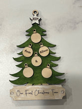 Load image into Gallery viewer, This beautiful Christmas Tree Personalized Ornament is sure to become a cherished, family favorite for years to come.  Add your loved ones and/or pets names to the ornaments on the tree to create a lasting keepsake.   Available in 3 different, hand painted styles and your choice of natural wood or colored ornaments.  Add a custom banner at the bottom to make it uniquely yours.  Please specify color of ornament and name when ordering.  