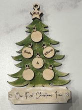 Load image into Gallery viewer, This beautiful Christmas Tree Personalized Ornament is sure to become a cherished, family favorite for years to come.  Add your loved ones and/or pets names to the ornaments on the tree to create a lasting keepsake.   Available in 3 different, hand painted styles and your choice of natural wood or colored ornaments.  Add a custom banner at the bottom to make it uniquely yours.  Please specify color of ornament and name when ordering.  