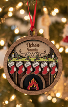 Load image into Gallery viewer, Celebrate everyone who makes your house a home with this beautiful Personalized Family Christmas Ornament. Featuring a cozy fireplace scene, personalized stockings, and your family name on the mantel, this hand-painted keepsake is a special way to celebrate your family at Christmas.