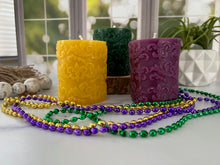 Load image into Gallery viewer, Elegant pillar candle embossed with a Fleur De Lis pattern is a beautiful year-round decorative candle and would complete any Mardi Gras table centerpiece or could make a fantastic gift for anyone who loves the New Orleans Saints or is of French ancestry. The soft light of the beeswax illuminates the Fleur De Lis design beautifully as it lights up your room.