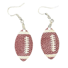 Load image into Gallery viewer, Score big on game day with our stylish Football Earrings! Designed with a realistic football-textured finish, these earrings are the perfect way to showcase your love for the game and your team spirit. Lightweight and easy to wear, they feature a sleek 1.5" football-shaped design that adds the perfect sporty touch to any outfit.