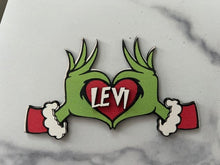 Load image into Gallery viewer, Embrace the humor and charm of the holiday season with our delightful Grouch Hands & Heart Personalized Ornaments – the ultimate gift for the Grouch in your life. Measuring approximately 5" wide x 2.5" long, these ornaments pack a punch of personality and are sure to bring a smile to anyone with a touch of the grumpies.
