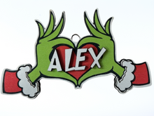 Load image into Gallery viewer, Embrace the humor and charm of the holiday season with our delightful Grouch Hands & Heart Personalized Ornaments – the ultimate gift for the Grouch in your life. Measuring approximately 5" wide x 2.5" long, these ornaments pack a punch of personality and are sure to bring a smile to anyone with a touch of the grumpies.