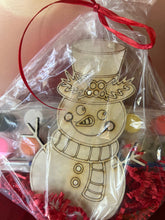Load image into Gallery viewer, Keep the littles busy this year with these fun Christmas Paint Kits featuring your choice of a Reindeer, Santa, a Snowman or a Christmas Dragon.  Masking is left on wood design to help children with painting them.  Peel each part before painting.