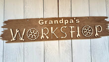 Load image into Gallery viewer, Transform your workshop into a space that truly reflects your craftsmanship with our extraordinary Workshop Sign. Welcome one and all to your creative haven and personalize this sign with your favorite craftsman's name prominently displayed at the top. Crafted with care, this sign is more than just an entrance statement; it's a celebration of your passion for creating.