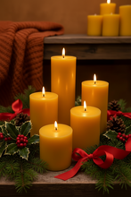 Load image into Gallery viewer, Classic 3" round beeswax pillar candles, available in 5 sizes (select size and quantity from drop down menus when ordering). These bright glowing pillars will fill the air with a natural hint of warm, fresh honey, purifying your air all the while. A favorite for housewarming gifts, these handmade candles are perfect for your needs and have a very long burn time! 