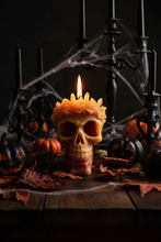 Load image into Gallery viewer, Add a hauntingly beautiful touch to your home with this Leaf Crown Skull Beeswax Candle. Featuring an intricately detailed skull adorned with a crown of leaves, this unique candle is perfect for lovers of gothic décor, Halloween decorating, dark cottagecore, and spooky home accents.