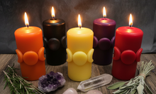 Load image into Gallery viewer, Bring a little magic into your home with this enchanting Moon Phase Beeswax Candle, featuring the Triple Goddess symbol surrounded by the colors of the seven chakras. Representing intuition, balance, feminine energy, and spiritual connection, this beautifully detailed candle is perfect for anyone drawn to Wiccan, Pagan, or mystical traditions.
