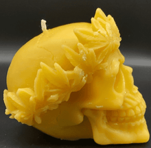 Load image into Gallery viewer, Large, Creepy, gothic skull beeswax candle with leaf crown.  Eyes glow when lit.  Halloween decor or gothic decor.  Side view.
