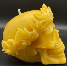 Load image into Gallery viewer, Large, Creepy, gothic skull beeswax candle with leaf crown.  Eyes glow when lit.  Halloween decor or gothic decor.  Side view.