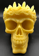 Load image into Gallery viewer, Large, Creepy, gothic skull beeswax candle with leaf crown.  Eyes glow when lit.  Halloween decor or gothic decor.