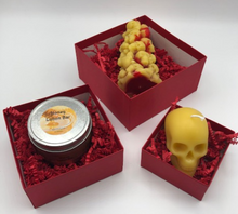 Load image into Gallery viewer, For that special goth or skull lover in your life, treat them to this gothic, creepy Valentines Day Gift Box Trio.  Set includes 1 Bleeding Skull and Bones Candle, 1 votive sized Skull Beeswax Candle and one Honey Lotion Bar all packaged up in a set of red stacked boxes and tied with a ribbon.