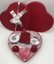 Load image into Gallery viewer, Unique Valentines Day Gift in red, heart shaped gift box.  Set includes 1 red beeswax Love & Roses Candle, 1 Lavender Lotion Bar, 1 Lavender Bath Bomb, 1 Lavender or Rose Geranium scented Heart Shaped Goat's Milk Soap & 2 Beeswax Red Rose Ball Candles.  Perfect for Valentines Day Gifts!