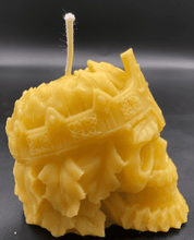 Load image into Gallery viewer, Creepy, ornate skull beeswax candle with cross crown.  Eyes glow after it starts to burn down.