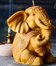 Load image into Gallery viewer, Georgeous Elephant / Ganesh Beeswax Candle is adorned in a decorative blanket & headpiece.  Elephants are symbolized as removers of obstacles and a provider of fortune and good luck.  In Indian culture, elephants are a symbol of mental strength, earthiness and responsibility.