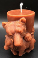 Load image into Gallery viewer, Mama and baby bear beeswax candle. All natural, sourced from an American, family owned apiary. Handmade in the USA. This Mama and Baby Bear beeswax candle looks absolutely stunning in any room when lit, as the soft glow lights up the cuddling duo. The scene wraps around the entire candle with images of bears in the wilderness. A wonderful compliment to any cabin or rustic design or as a gift to the outdoorsy types in your life.  Brown shown.