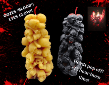 Load image into Gallery viewer, Bleeding Skull Beeswax Candle, piles of skulls and bones with a red leaking core.  Incredible candle that oozes 'blood', the skull eyes glow as it burns, the heads pop off around the plate & it burns about 15 hours!!!