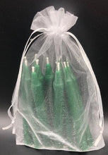 Load image into Gallery viewer, Set of 12 Chime Beeswax Candles.  These are the perfect candle to bring attention and intention to the moment.  Packaged in bags of 12.  Kept out of drafts and away from fans, these mini tapers will burn virtually dripless for roughly two hours.  Perfect for meditation, prayer candles, ritual candles or alter candles.  Available in Natural (gold) beeswax, cream, purple, pink, red, blue, green, orange, brown or black.  Shown in green in a pretty organza bag.
