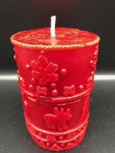Load image into Gallery viewer, A great addition to any holiday decor, this Christmas Beeswax Pillar Candle is decorated with snowflakes, Christmas trees and cute little moose. Makes a wonderful gift, addition to your Christmas decor, or as a centerpiece. Available in red, green or natural yellow beeswax.