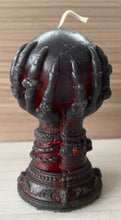 Load image into Gallery viewer, Our Witch Holding a Crystal Ball Beeswax Candle is an enchanting addition to any witchy, gothic or Halloween decor! The intricate detailing around the base of the candle features decorative skulls. The witch hand is adorned with bracelets, rings & long, sharp fingernails adding to the eerie vibe of this incredible beeswax candle.