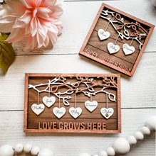 Load image into Gallery viewer, Beautiful wood Family Tree sign with hearts hanging down from branches with your family's names on each heart. You can add up to 25 names to each frame. At the bottom, we offer over 100 different options for wording on these custom home decor signs. Happy Mother's Day, We (heart) Mom, Happy Father's Day, We (heart) Grandma and many more.