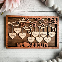 Load image into Gallery viewer, Beautiful wood Family Tree sign with hearts hanging down from branches with your family's names on each heart. You can add up to 25 names to each frame. At the bottom, we offer over 100 different options for wording on these custom home decor signs. Happy Mother's Day, We (heart) Mom, Happy Father's Day, We (heart) Grandma and many more.