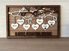 Load image into Gallery viewer, Beautiful wood Family Tree sign with hearts hanging down from branches with your family's names on each heart. You can add up to 25 names to each frame. At the bottom, we offer over 100 different options for wording on these custom home decor signs. Happy Mother's Day, We (heart) Mom, Happy Father's Day, We (heart) Grandma and many more.