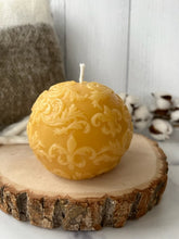 Load image into Gallery viewer, This beautiful sphere Fleur De Lis beeswax candle is a great addition to a dining room table or an entryway and can make a fantastic gift for anyone who loves the New Orleans Saints or is of French ancestry.  The soft light of the beeswax illuminates the Fleur De Lis design beautifully as it lights up your room.  Available in natural, purple or green.  
