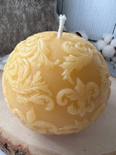 Load image into Gallery viewer, This beautiful sphere Fleur De Lis beeswax candle is a great addition to a dining room table or an entryway and can make a fantastic gift for anyone who loves the New Orleans Saints or is of French ancestry. The soft light of the beeswax illuminates the Fleur De Lis design beautifully as it lights up your room. Available in natural, purple or green.