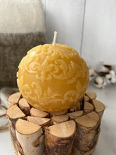 Load image into Gallery viewer, This beautiful sphere Fleur De Lis beeswax candle is a great addition to a dining room table or an entryway and can make a fantastic gift for anyone who loves the New Orleans Saints or is of French ancestry.  The soft light of the beeswax illuminates the Fleur De Lis design beautifully as it lights up your room.  Available in natural, purple or green.  
