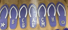 Load image into Gallery viewer, Add a bit of summer to your entry way with this Flip Flop Welcome Door Hanger Sign.  These adorable flip flops spelling out WELCOME invite guest into your home.  Perfect for lake houses, beach retreats or just to add a bit of summer decor.