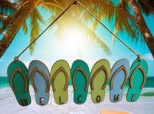 Load image into Gallery viewer, Add a bit of summer to your entry way with this Flip Flop Welcome Door Hanger Sign.  These adorable flip flops spelling out WELCOME invite guest into your home.  Perfect for lake houses, beach retreats or just to add a bit of summer decor.