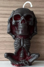Load image into Gallery viewer, Each beeswax candle measures 4" tall x 2 3/16" wide, and weighs approximately 2 ounces, makin them the perfect size for any room in your home.  The three skulls feature a unique design, embodying the classic "see no evil, hear no evil, speak no evil" phrase.  Available in a black exterior with red core or a yellow exterior with red core.