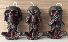 Load image into Gallery viewer, Each candle measures 4" tall x 2 3/16" wide, and weighs approximately 2 ounces, makin them the perfect size for any room in your home.  The three skulls feature a unique design, embodying the classic "see no evil, hear no evil, speak no evil" phrase.