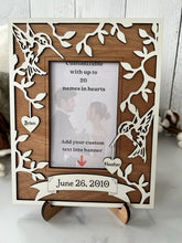Load image into Gallery viewer, This Hummingbird Photo Frame is the perfect way to display your cherished memories with loved ones.  This unique and personalized photo frame can be customized with up to 20 names in the hearts hung around the frame and custom wording in the banner across the bottom, making it a special and meaningful addition to any home decor.  Available for a 4" x 6" or a 5" x 7" photo.