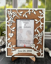 Load image into Gallery viewer, This Hummingbird Photo Frame is the perfect way to display your cherished memories with loved ones. This unique and personalized photo frame can be customized with up to 20 names in the hearts hung around the frame and custom wording in the banner across the bottom, making it a special and meaningful addition to any home decor. Available for a 4" x 6" or a 5" x 7" photo.